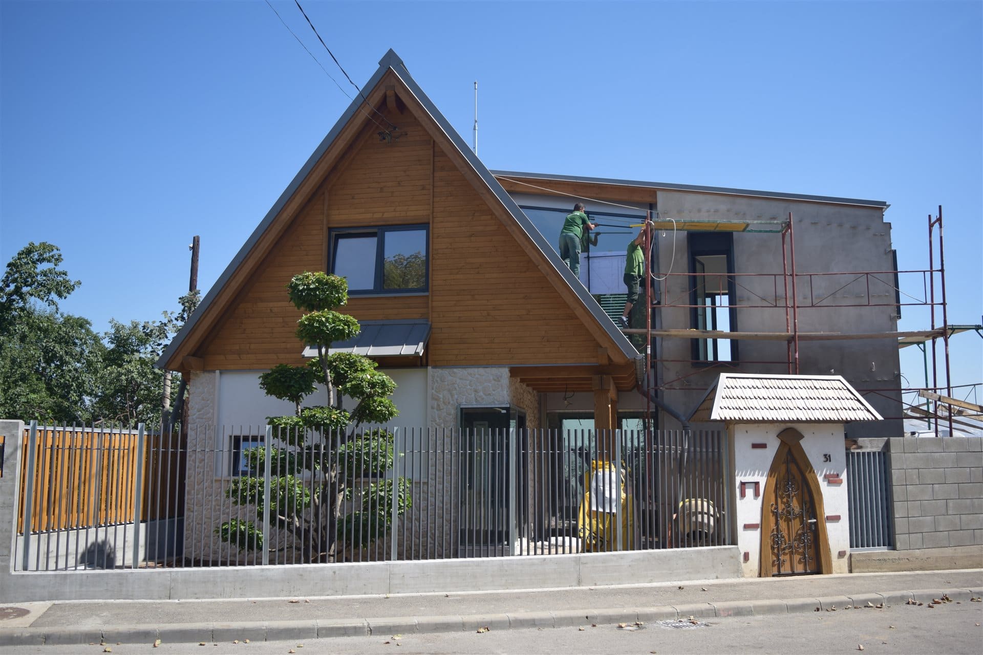 Cluj Hillside Residence — timber gable and façade glazing during installation
